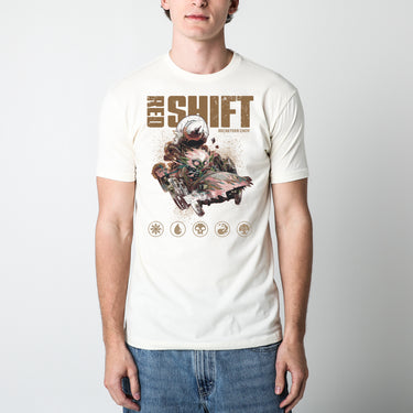 a male model wearing a natural Magic: The Gathering t-shirt featuring Redshift, the Rocketeer Chief, in a chaotic, steampunk-inspired vehicle with a massive rocket strapped to the back. The goblin-like character has wild white hair, glowing eyes, and a mischievous grin as he speeds forward. The distressed artwork includes grunge-style textures, the bold text 'Red Shift' at the top, and Magic: The Gathering mana symbols along the bottom.