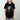A female model featuring a moody graphic tee featuring Daredevil crouched in front of a weathered clock tower, drenched in rain. The distressed artwork and bold red highlights capture the grit and intensity of Hell’s Kitchen’s vigilante.








