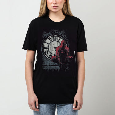 A female model featuring a moody graphic tee featuring Daredevil crouched in front of a weathered clock tower, drenched in rain. The distressed artwork and bold red highlights capture the grit and intensity of Hell’s Kitchen’s vigilante.








