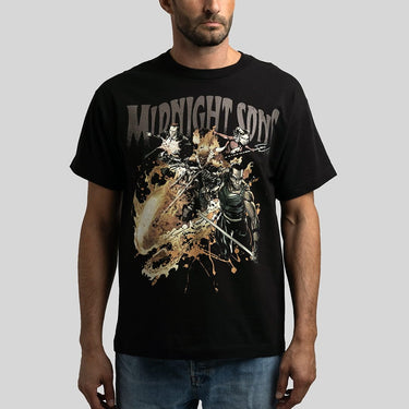 A man wearing a black short-sleeve graphic t-shirt with a large distressed print reading 'MIDNIGHT SONS"