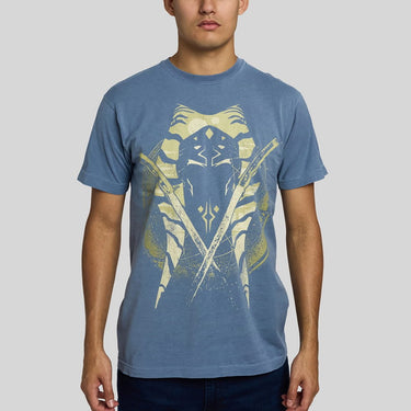 Man in a blue crewneck t-shirt featuring a distressed graphic of Ahsoka Tano's face, crossed lightsabers, and a circular emblem on the front, set against a plain light gray background.