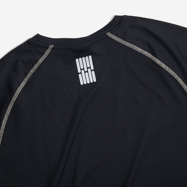Black athletic shirt with white logo on a light gray background