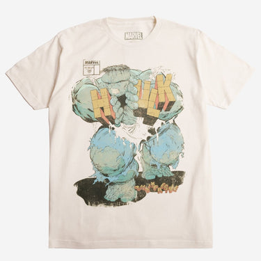 Off White T-shirt with a graphic design of a The Incredible Hulk Comic Cover depicting The Hulk pushing through his name between the "H" and "ULK" on a beige background
