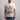 Person wearing a t-shirt with a graphic design of a character's fists and the word 'Hulk'.