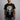 Person wearing a black Marvel t-shirt with a Punisher skull design on a gray background