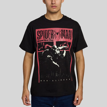 A man wearing A black short-sleeve crewneck t-shirt featuring a prominent red and black graphic print of Spider-Man on the front, with 'SPIDER-MAN' and 'Brand New Day' printed above an action scene.