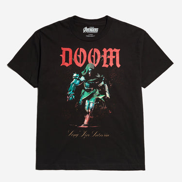 A black short-sleeve graphic t-shirt featuring the word 'DOOM' in red gothic lettering above a stylized green and red armored character, with 'Long Live Latveria' printed below on a light gray background.