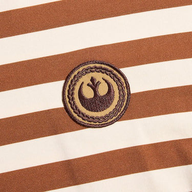 Photo shows a  close up of a t-shirt with white and orange horizontal stripes.  There is a circular patch with the Star Wars Rebel emblem. The emblem is within a braided circle that represents princess leias iconic braids. 