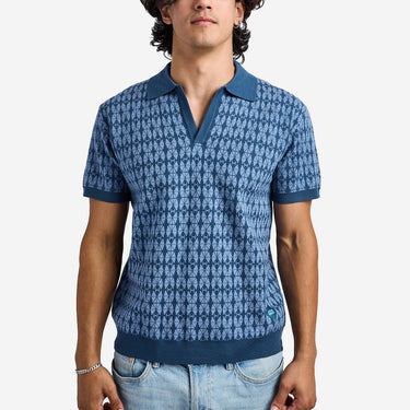 Man wearing a blue star wars patterned polo shirt against a white background