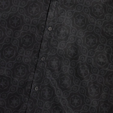 A close up of a button up black shirt with red details in a star wars imperial geometric pattern 