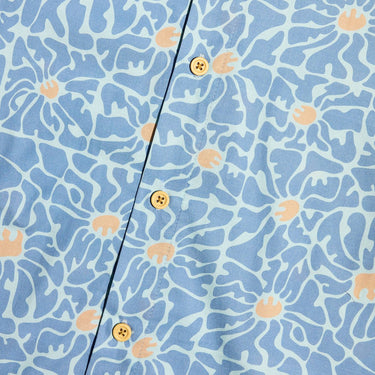 A close up of a blue button down star wars rebel shirt with 60s inspired patterns