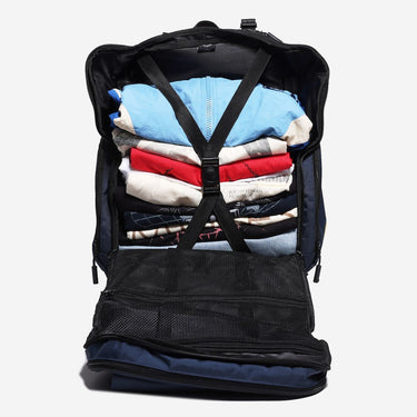 Backpack with clothes neatly packed inside on a white background