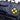 Blue bag with a yellow and black circular emblem featuring a large 'X'.