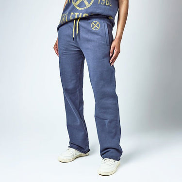A Woman in Blue sweatpants with an elastic waistband and yellow drawstring, featuring a small yellow x-men logo near the left pocket and a vertical "Xavier" graphic printed in distressed yellow text along the lower left leg.