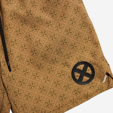 Gold patterned shorts with a black circular design on a white background